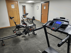 Marshall apartment for rent - A gym room with a treadmill, elliptical trainer and a rowing machine.