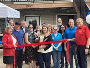 Willmar apartment for rent - A group of people are gathered for a ribbon cutting ceremony.