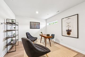 Decatur townhouse for rent - A living room with a brown chair and a wooden table.