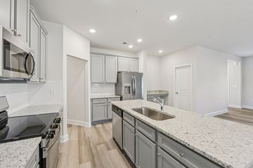 Covington townhouse for rent - A modern kitchen with granite countertops and stainless steel appliances.