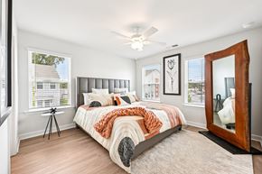 Decatur townhouse for rent - A bedroom with a large bed and a large mirror on the wall.