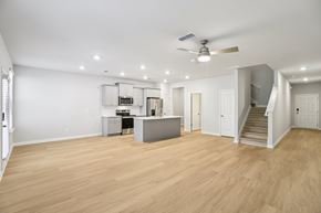 Hampton townhouse for rent - A spacious room with wooden flooring and a ceiling fan.