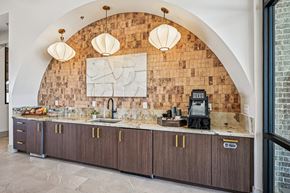 Canton townhouse for rent - A kitchen with a brick wall and wooden cabinets.