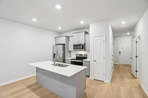 Hampton townhouse for rent - A kitchen with white cabinets and a white island.