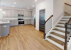 Covington apartment for rent - A kitchen with wooden floors and a staircase with wooden steps.