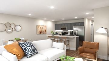 Charlotte apartment for rent - A modern living room with a white sofa and a brown armchair.