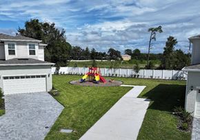 St. Cloud townhouse for rent - A backyard with a playground and a white fence.