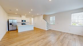 Covington townhouse for rent - A spacious room with wooden floors and a staircase.