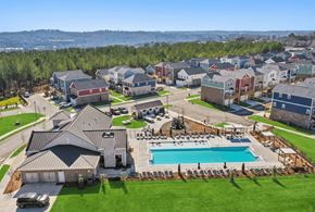 Canton townhouse for rent - A large house with a pool in the foreground and a row of houses in the background.