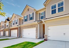 Covington townhouse for rent - A row of houses with garages and driveways.