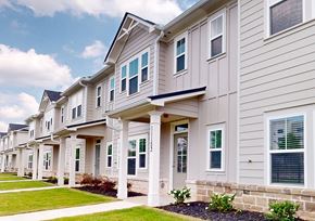 Covington townhouse for rent - A row of houses with a blue sky in the background.