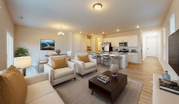 Holly Springs townhouse for rent - a living room with couches and a coffee table in front of a kitchen