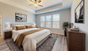 Holly Springs townhouse for rent - a bedroom with a large bed and a ceiling fan