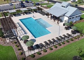Troutman apartment for rent - An outdoor pool area with a large rectangular pool, a pergola, and a small building.