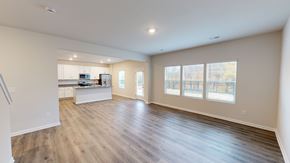 Troutman apartment for rent - A spacious living room with hardwood floors and large windows.