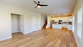 Winder apartment for rent - A spacious room with wooden floors and a ceiling fan.
