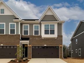 Holly Springs townhouse for rent - a house with two garage doors in front of it