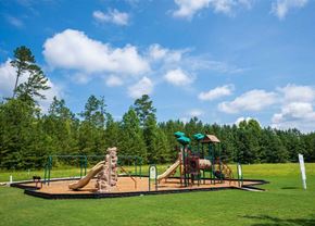 Dallas apartment for rent - A playground with a slide and a climbing structure.