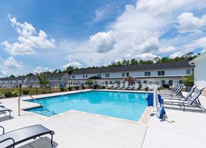 Chattanooga townhouse for rent - A swimming pool with lounge chairs and a building in the background.