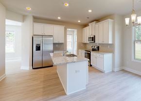 Conyers apartment for rent - A kitchen with white cabinets and a center island.