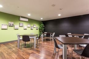 San Diego apartment for rent - a dining room with tables and chairs and a green wall