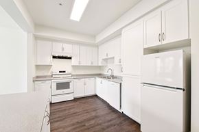 Los Angeles apartment for rent - A white kitchen with a refrigerator on the right.