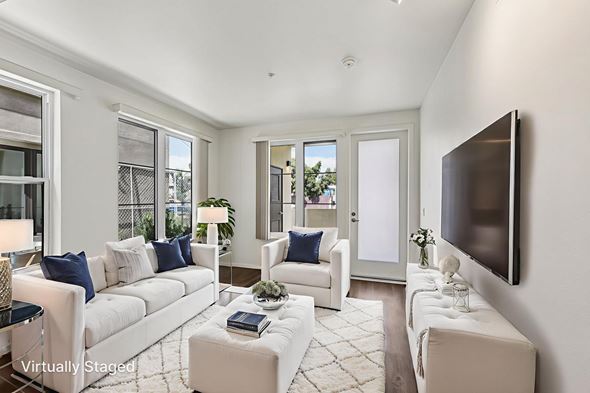 Los Angeles apartment for rent - A living room with white furniture and a flat screen TV mounted on the wall.