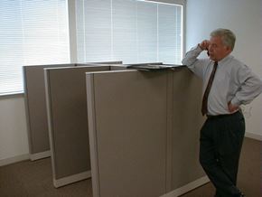 Oakland apartment for rent - an old man standing next to a filing cabinet in an office