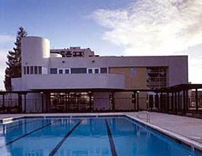 Oakland apartment for rent - a large swimming pool in front of a building