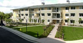 Pleasant Hill apartment for rent - an apartment building with green grass and a sidewalk in front of it
