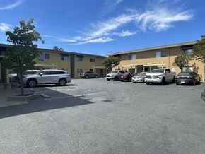 San Rafael apartment for rent - a parking lot with cars in front of a building