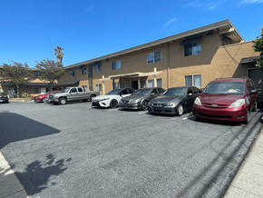 San Rafael apartment for rent - a parking lot filled with cars in front of a building