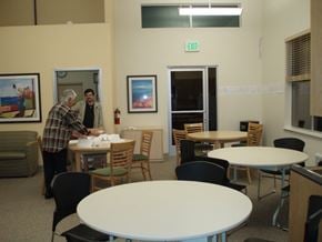 San Rafael apartment for rent - a man standing at a table in a room with tables and chairs