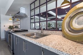 San Diego apartment for rent - a kitchen with granite counter tops and a stainless steel sink