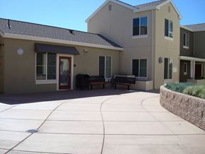 South San Francisco apartment for rent - the front of a building with a concrete walkway and a bench