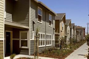 Oakland apartment for rent - a row of houses with a sidewalk in front of them