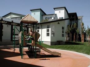 Oakland apartment for rent - a man playing on a playground     in front of a house