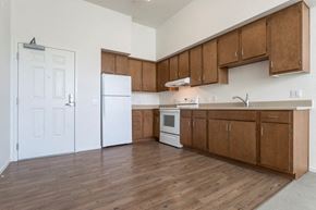 San Diego apartment for rent - an empty kitchen with wooden cabinets and a white refrigerator