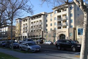 Oakland apartment for rent - a city street with cars parked in front of an apartment building
