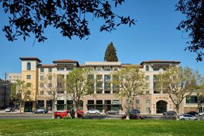 Oakland apartment for rent - a large building with cars parked in front of it