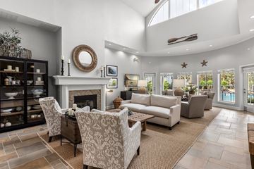 Titusville apartment for rent - A living room with a fireplace and a large mirror on the wall.