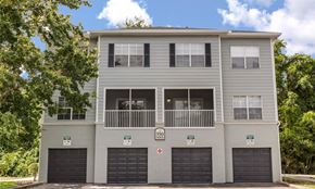 Titusville apartment for rent - A grey two-story building with a balcony on the second floor.
