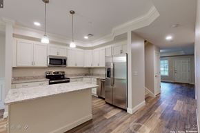 Pembroke apartment for rent - a kitchen with white cabinets and a stainless steel refrigerator