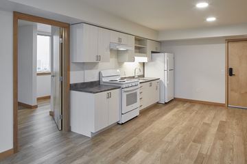 Portland apartment for rent - a kitchen with white cabinets and a stove and a refrigerator