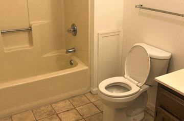 Beaver Springs apartment for rent - A white toilet in a bathroom with a bathtub and towel bar.