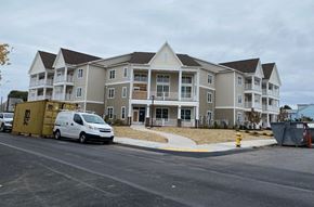 Frackville apartment for rent - A white van is parked in front of a large apartment building.