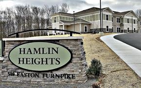 Lake Ariel apartment for rent - Hamlin Heights residential complex with a bridge and houses in the background.