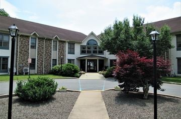 Waymart apartment for rent - A building with a stone wall and a tree in front.