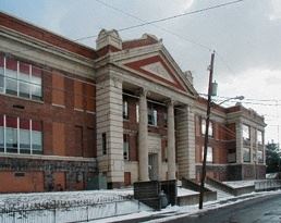 Pittston apartment for rent - A large red brick building with a white trim.