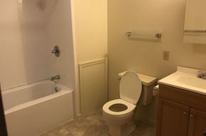 Elysburg apartment for rent - A white toilet is in a bathroom with a white bathtub and sink.